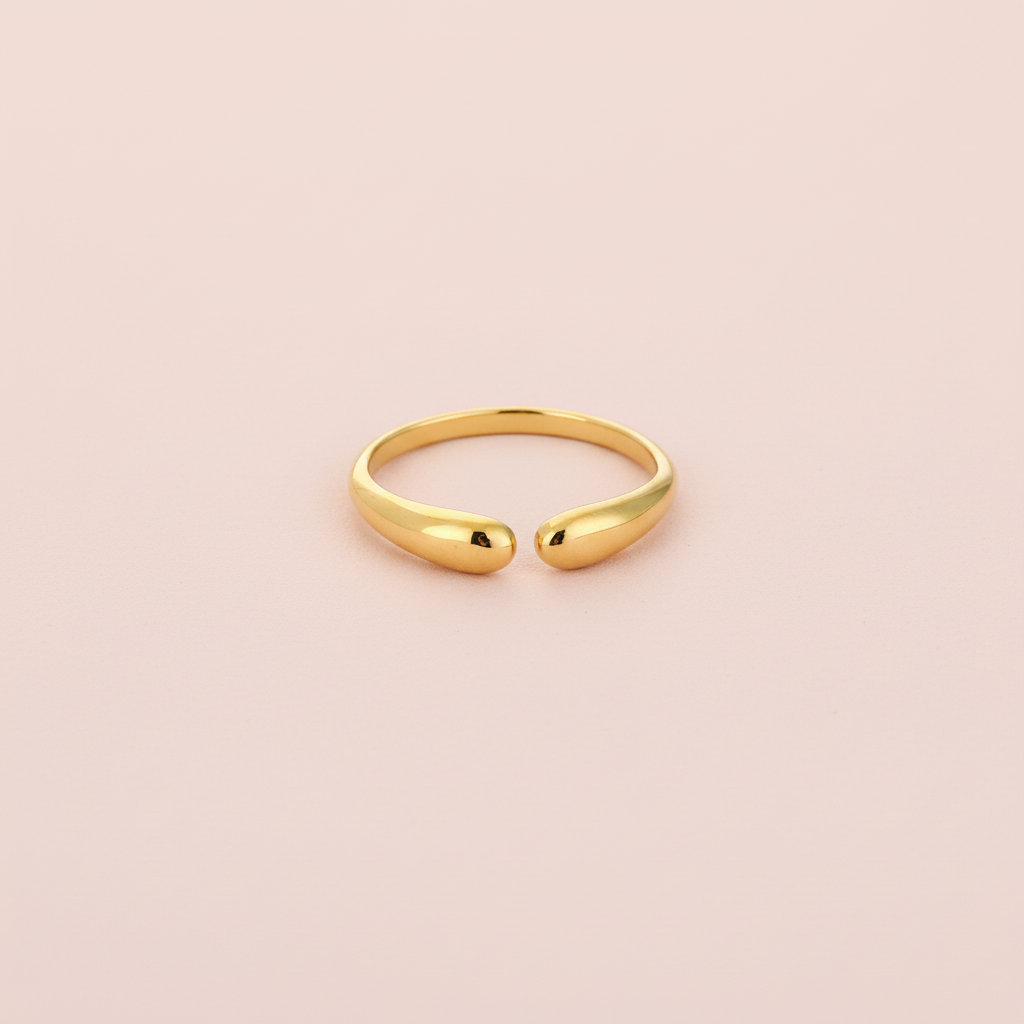 Gouden druppelring lichtroze achtergrond