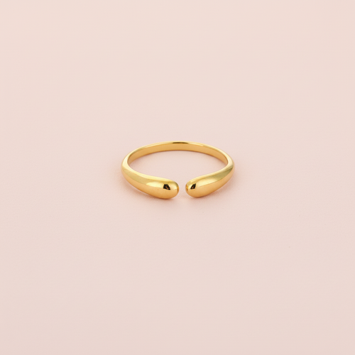 Gouden druppelring lichtroze achtergrond